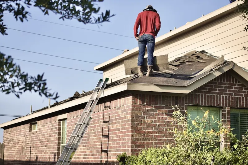 Professional roofer working on a residential roof in Highland Lakes